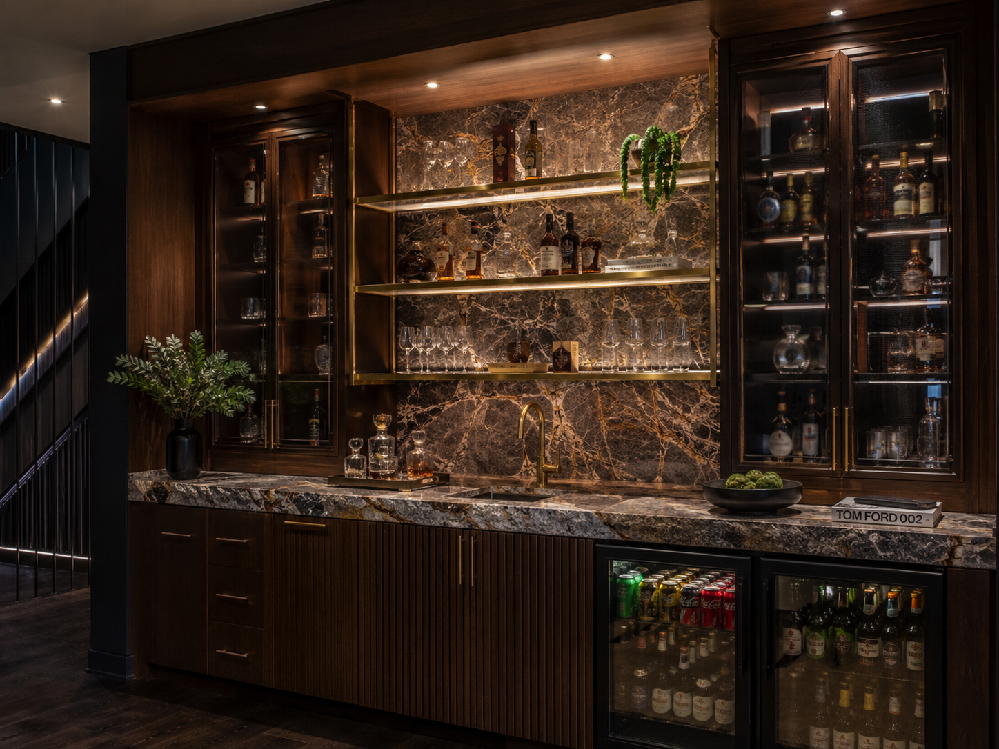 Moody luxury home bar with walnut cabinetry and marble